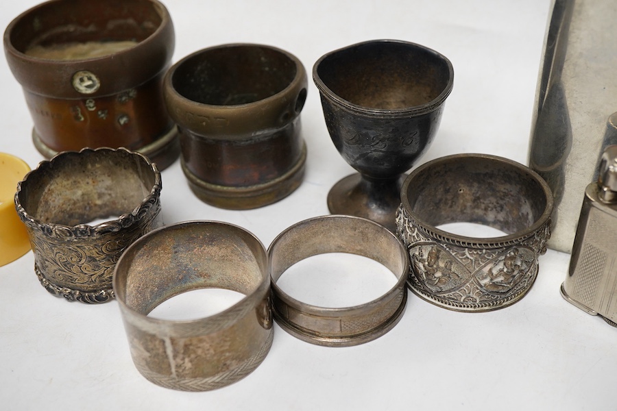 Four assorted silver napkin rings, an Indian white metal napkin ring, a small silver egg cup and four other items.